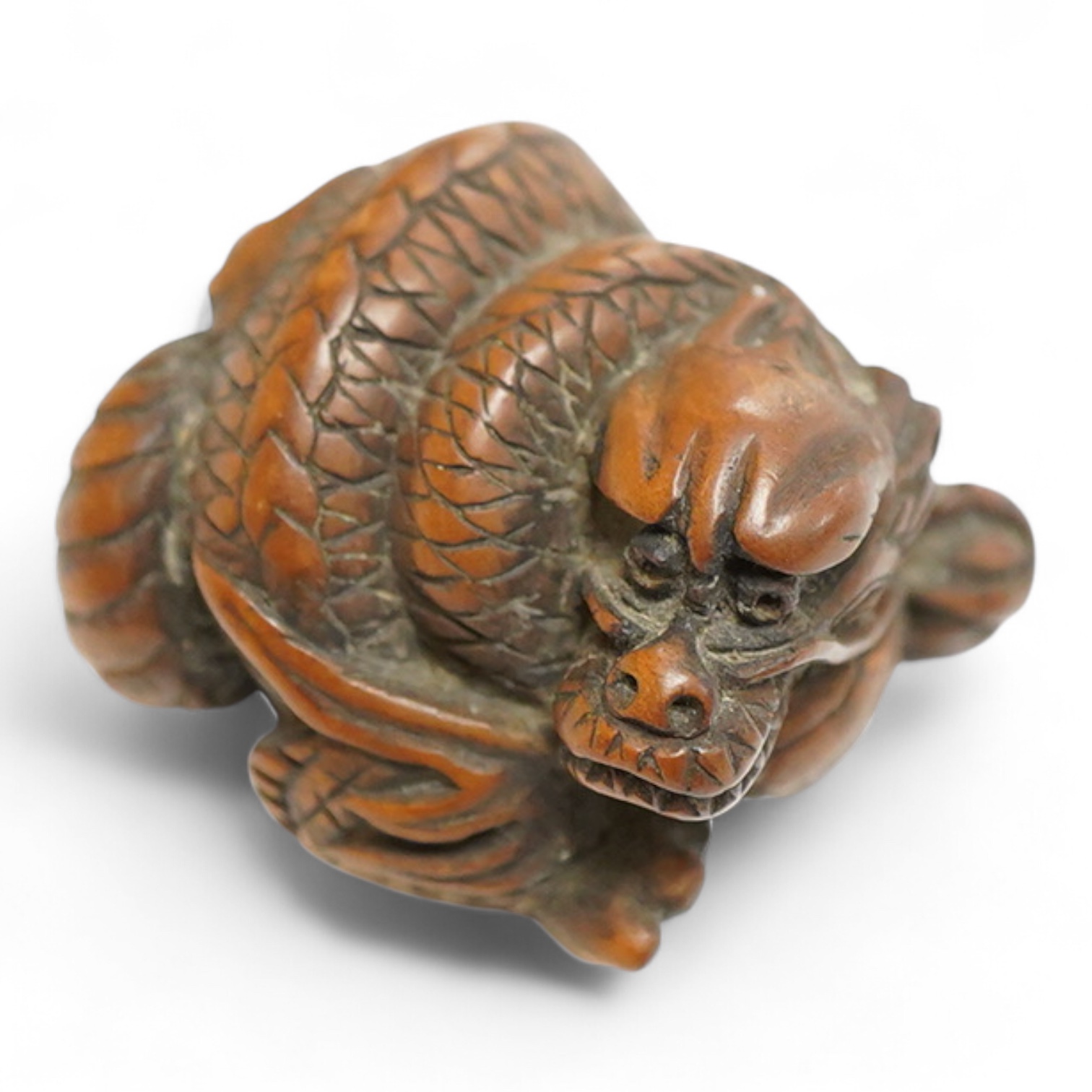 A 19th century Japanese carved wood ‘dragon’ netsuke, 4cm wide